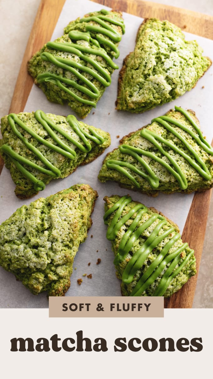Matcha scones drizzled with matcha icing scattered on a wooden board.