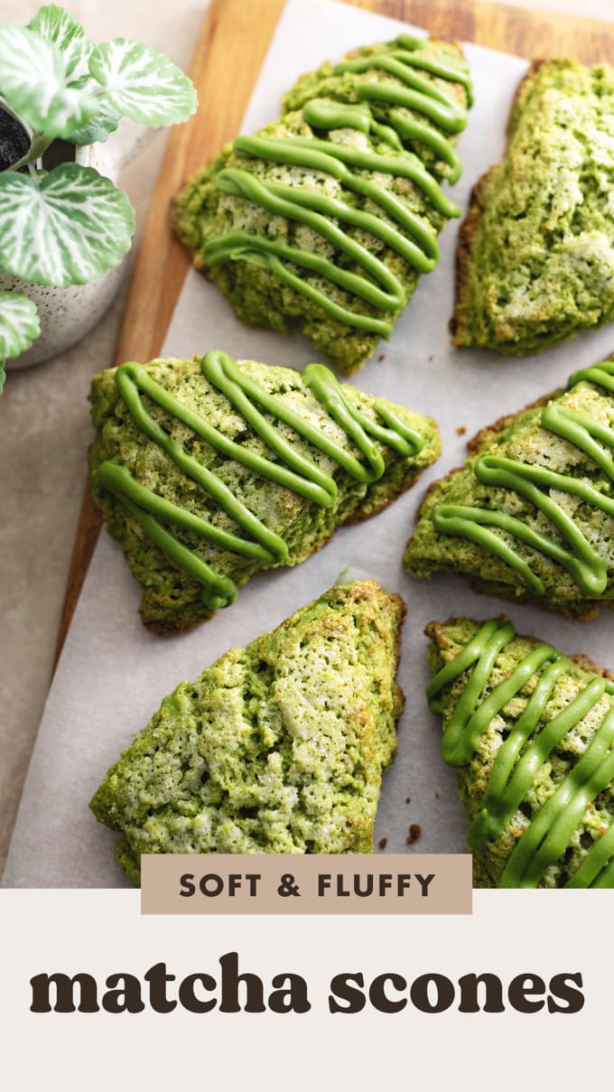 Matcha scones drizzled with matcha icing scattered on a wooden board.