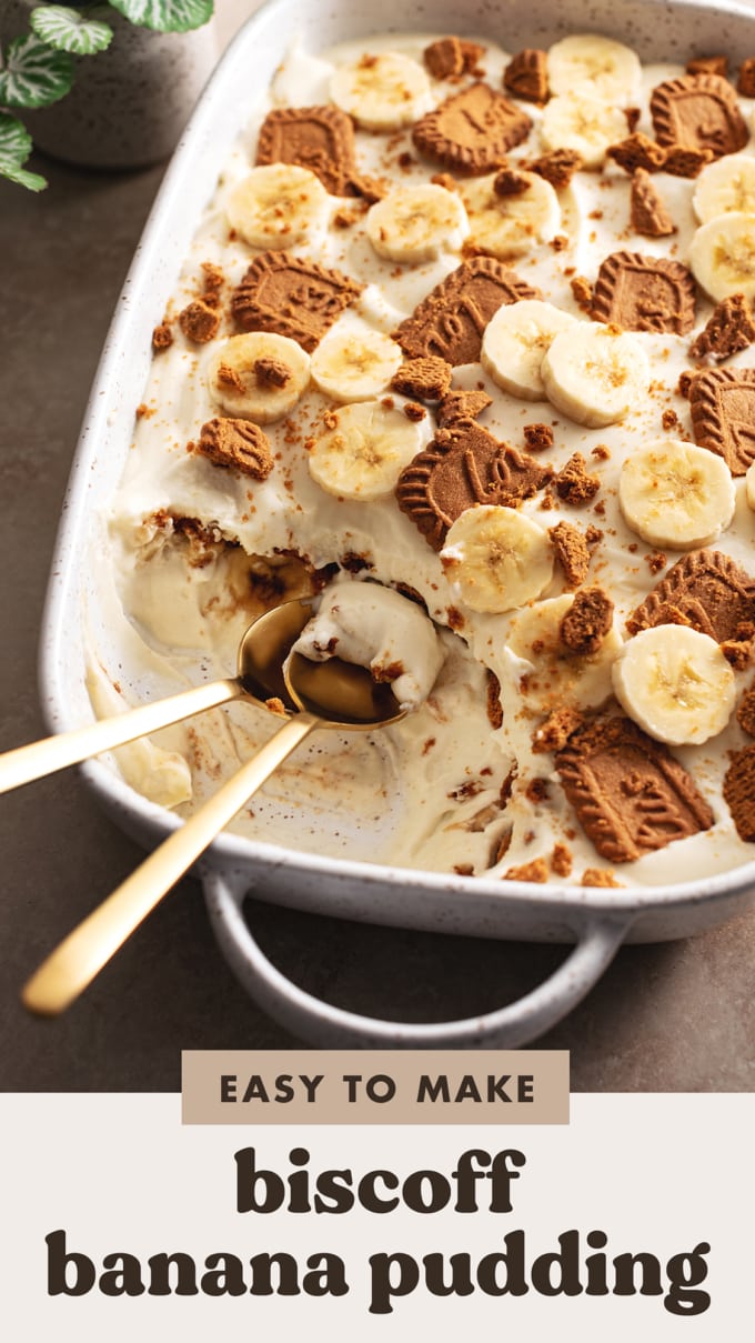 Two spoons in a serving dish of biscoff banana pudding where a section has been scooped out.