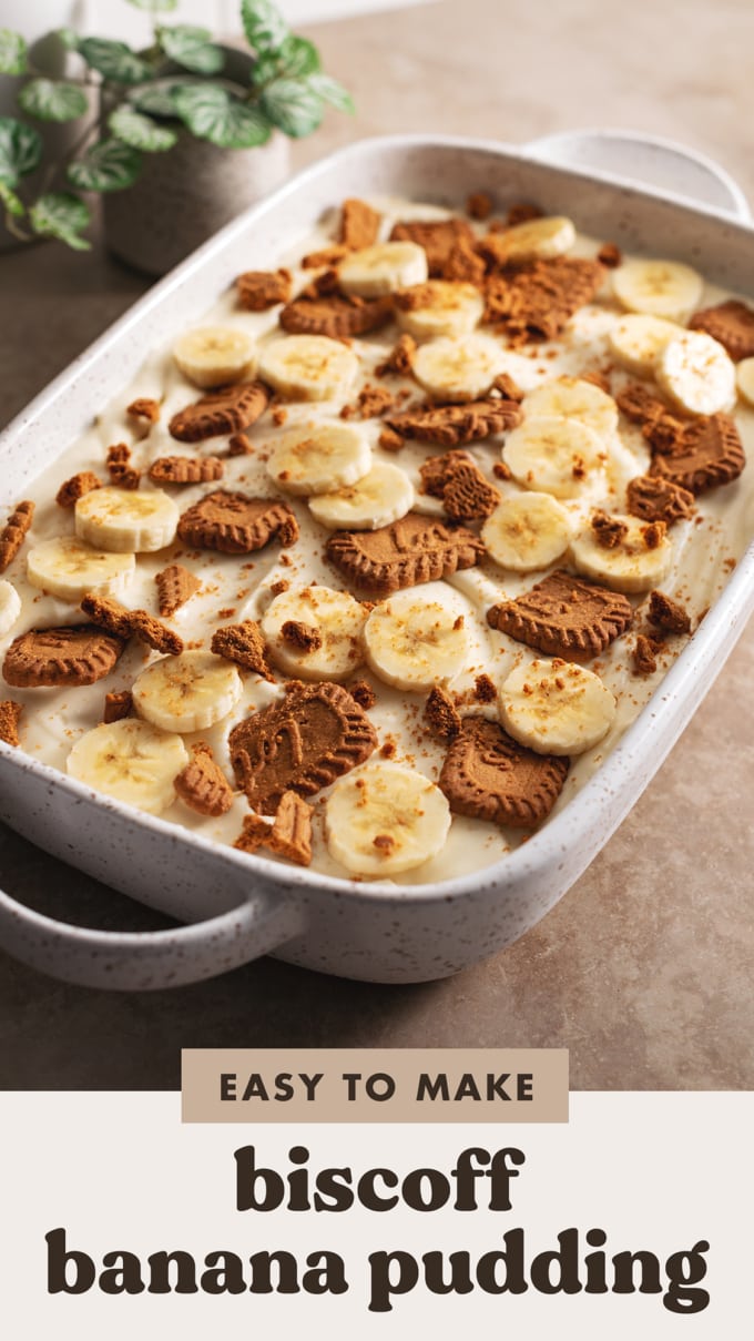 Biscoff banana pudding topped with crumbled biscoff cookies and banana slices in a large serving dish.