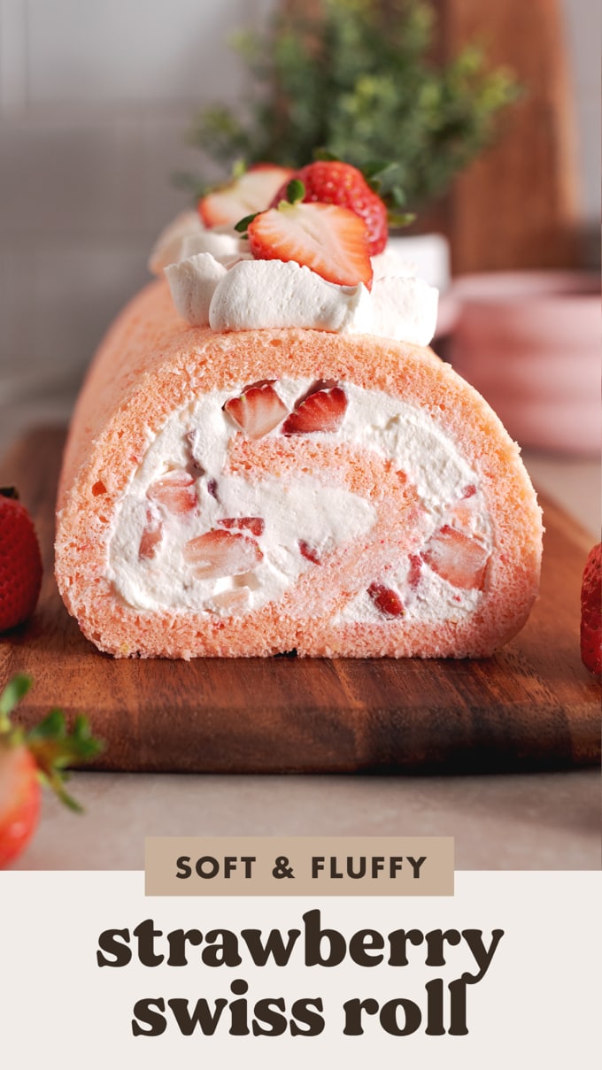 Cross-section view of the end of a strawberry swiss roll to show the filling inside.