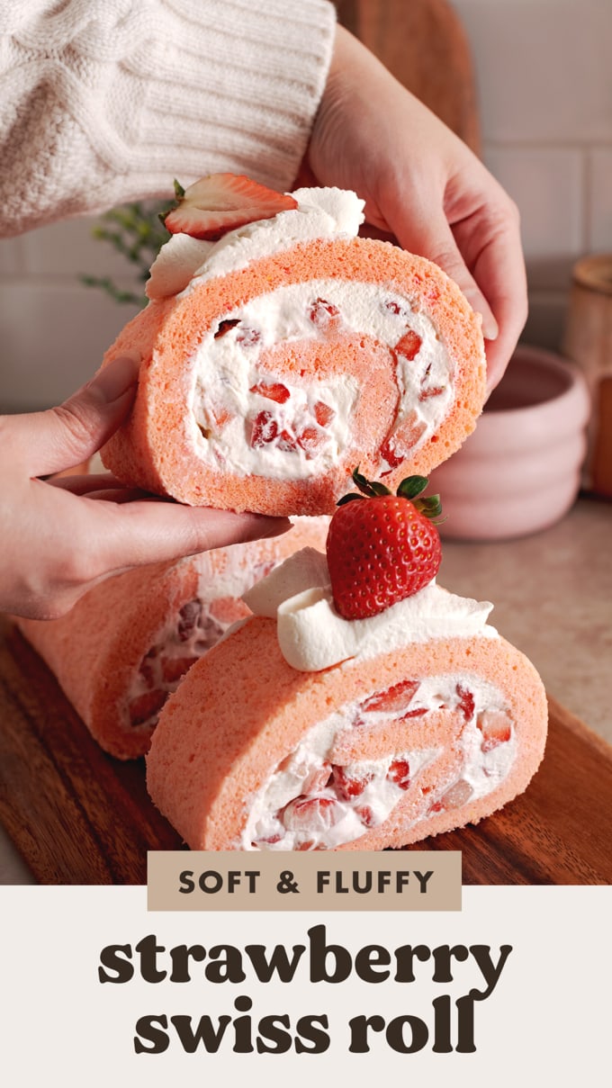 Hands lifting a slice of strawberry roll cake above the rest of the slices.
