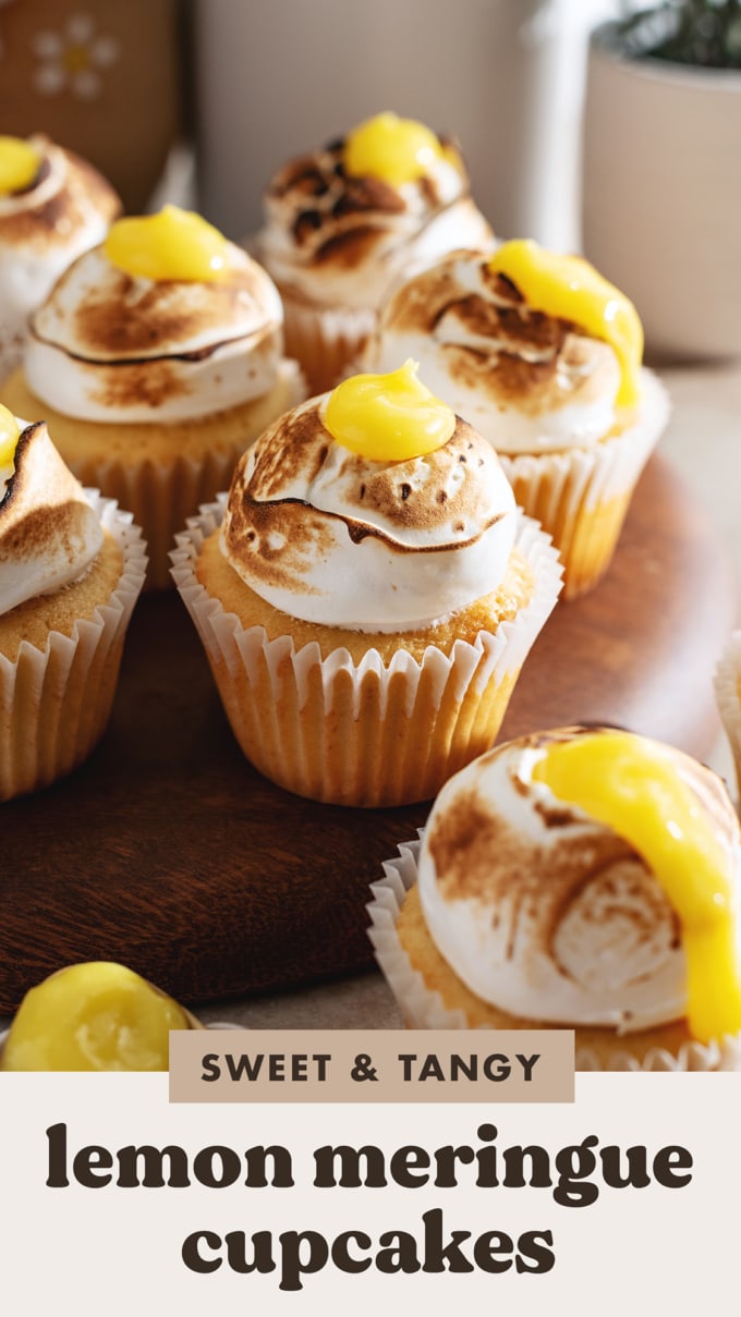 Close up of a lemon meringue cupcake with toasted meringue and lemon curd on top.
