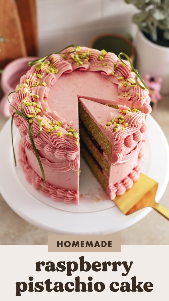 A slice of raspberry pistachio cake cut from the cake.