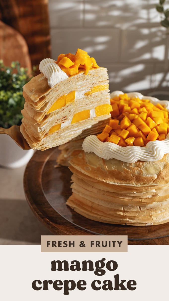 A slice of mango crepe cake lifted from the rest of the cake with a cake server.