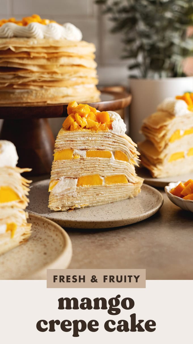 A slice of mango crepe cake on a plate showing the layers of crepes and mangoes.