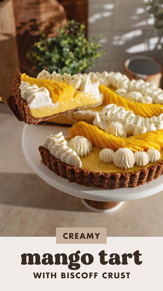 A slice of mango tart lifted from the rest of the tart with a cake server.