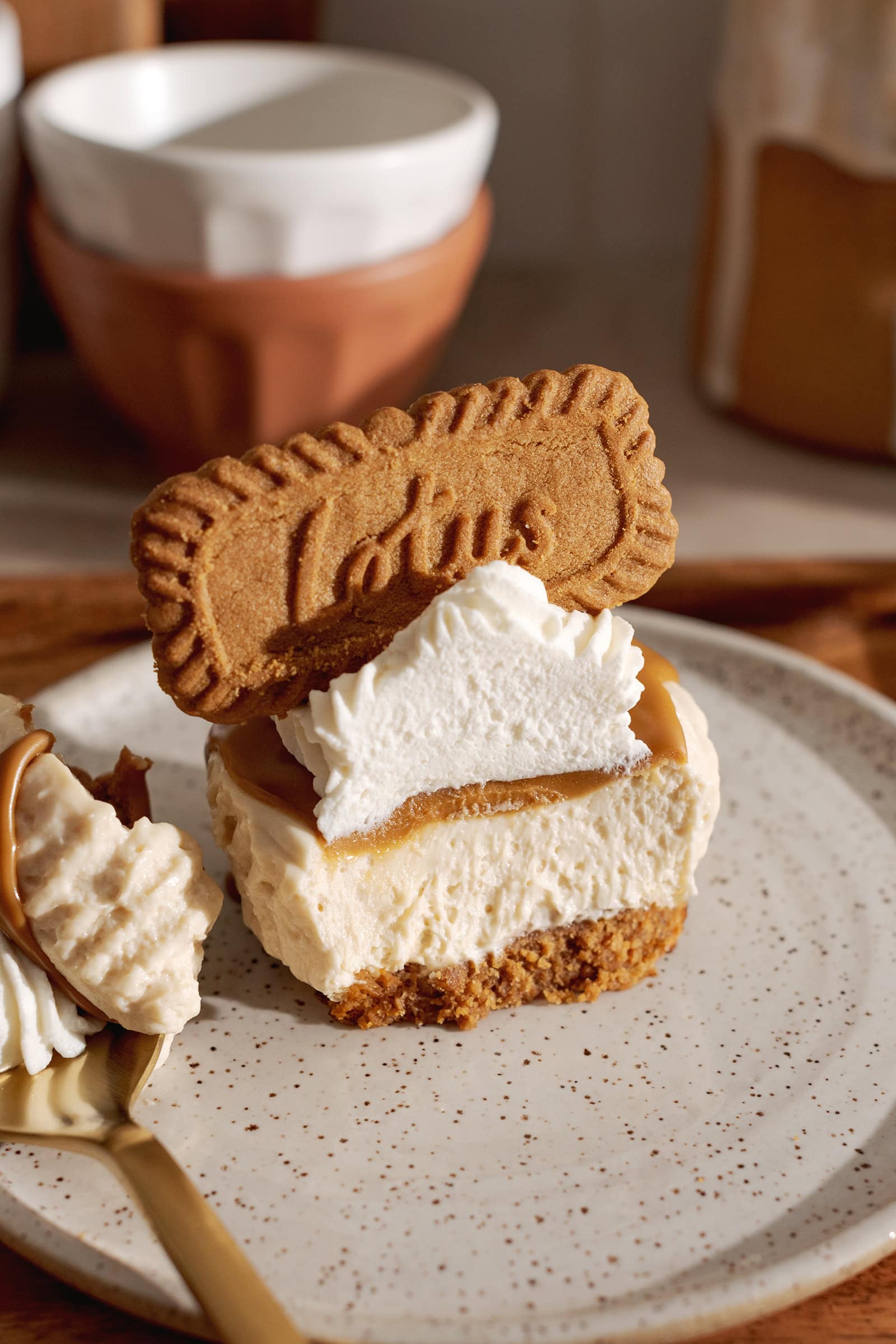 A mini biscoff cheesecake cut in half to show the texture inside.