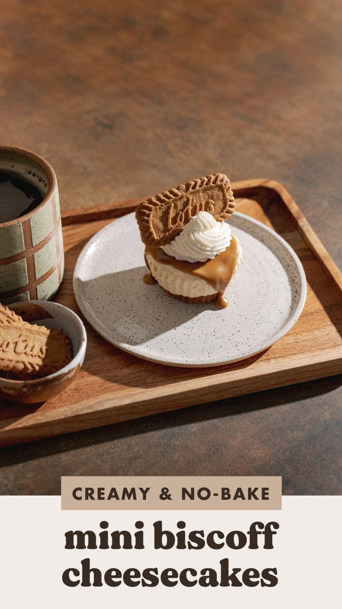 A single mini biscoff cheesecake on a wooden serving tray with a mug of coffee.