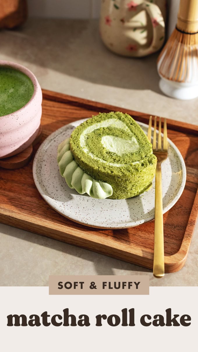 A slice of matcha roll cake on a plate with a fork.
