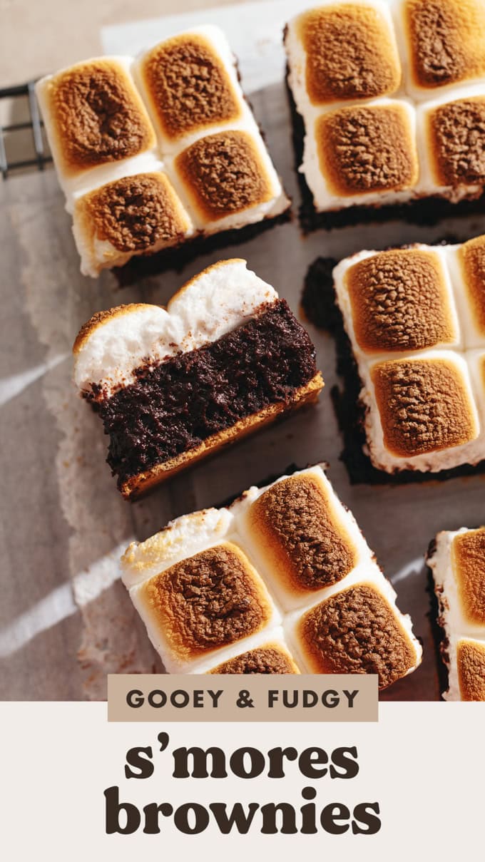A s'mores brownie laying on its side to show the layers of graham cracker, brownie, and marshmallow.