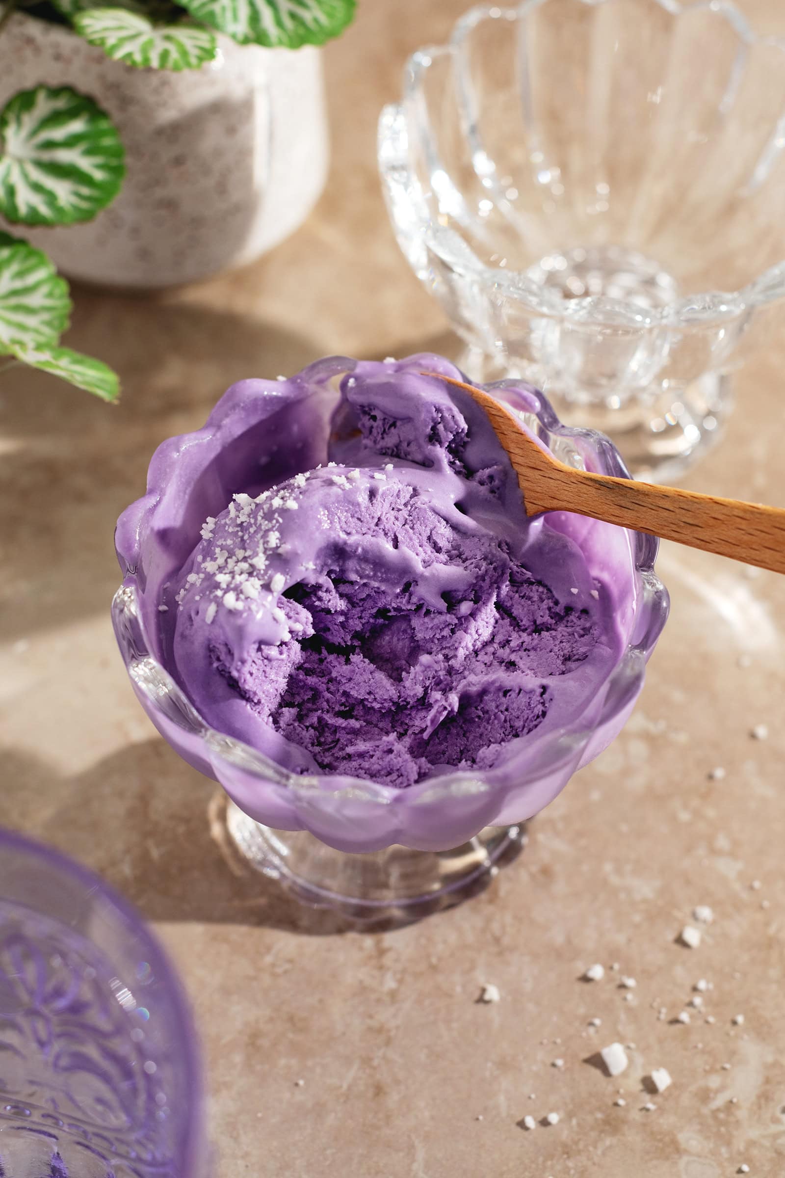 A bowl of half eaten melting ice cream with a spoon.