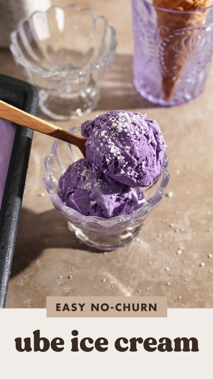 Two scoops of ube ice cream in a bowl with a spoon.