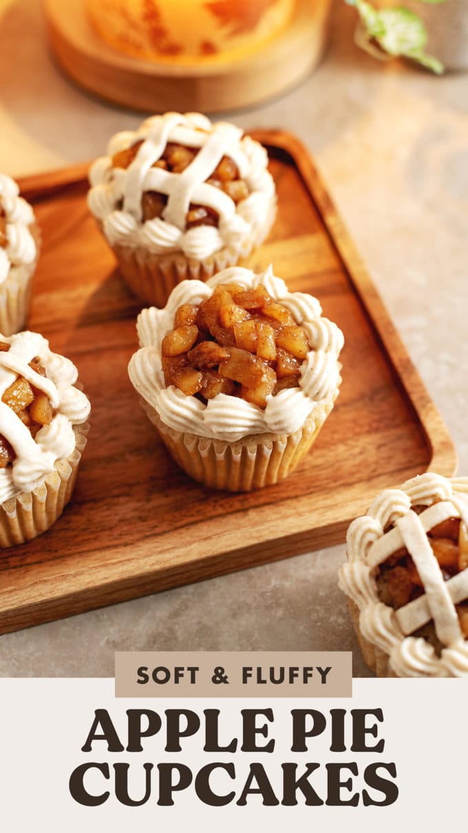 An apple pie cupcake topped with apple compote surrounded by cream cheese icing.