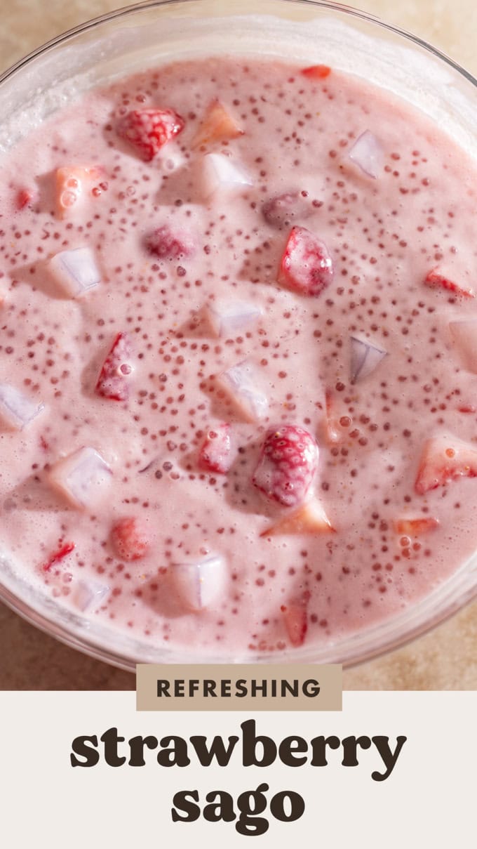 Overhead view of a big bowl of strawberry sago studded with strawberry chunks and coconut jellies.