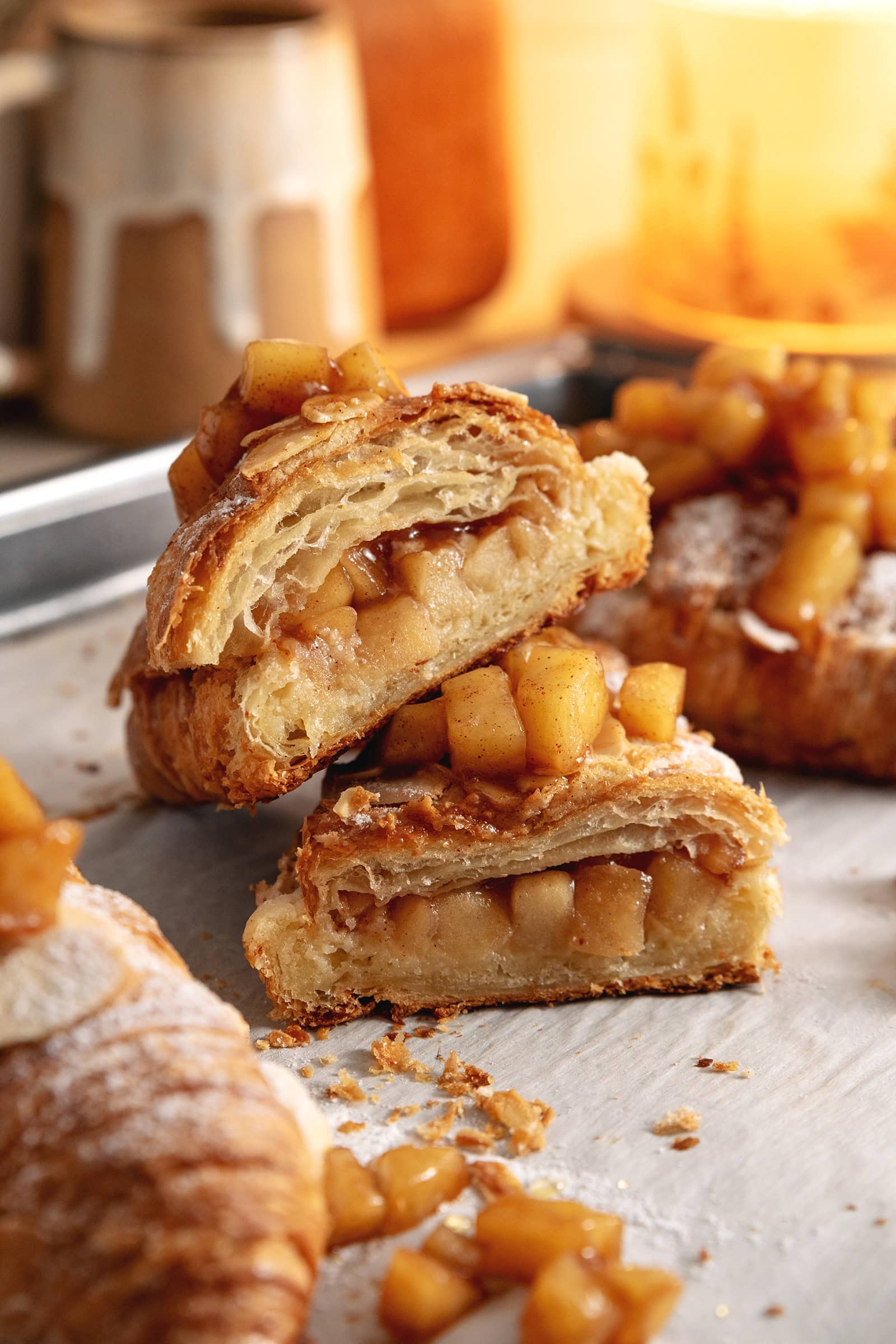 An apple pie almond croissant cut in half to show the filling inside.
