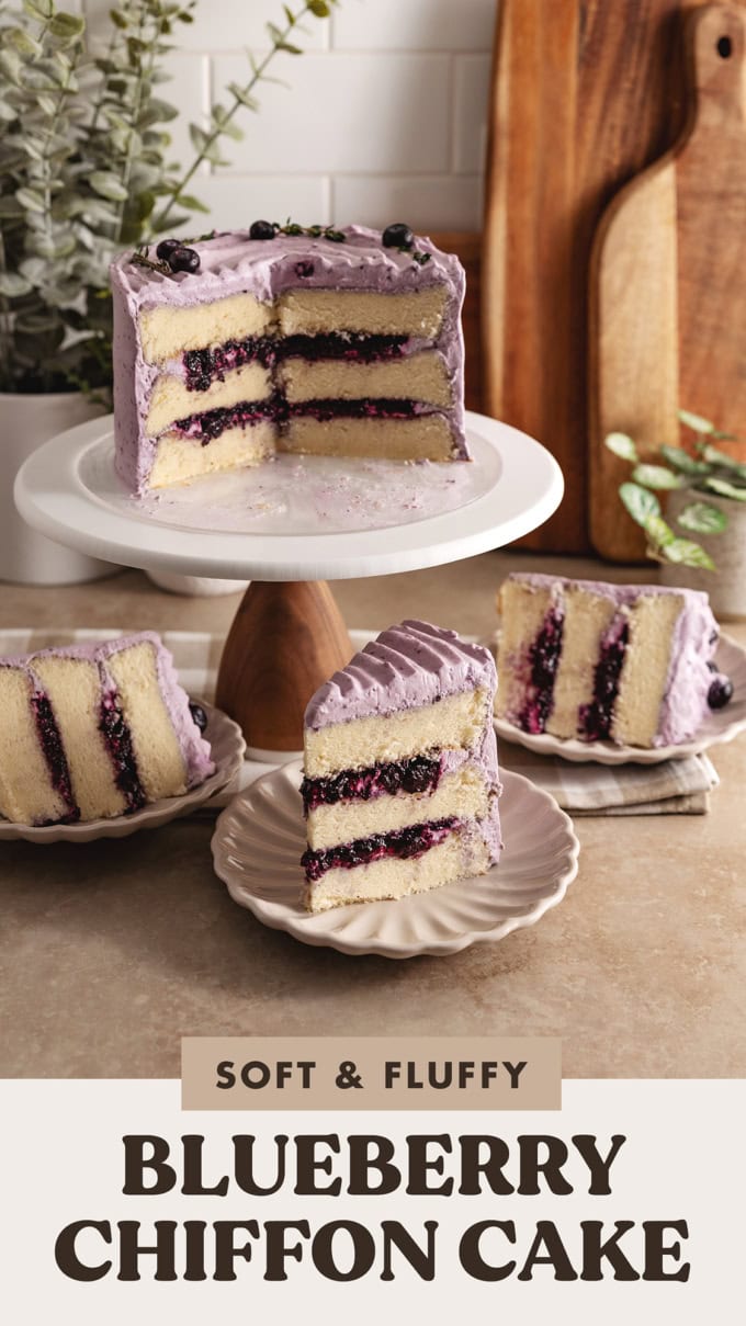 Slices of blueberry chiffon cake on plates surrounding the rest of the cake on a cake stand.