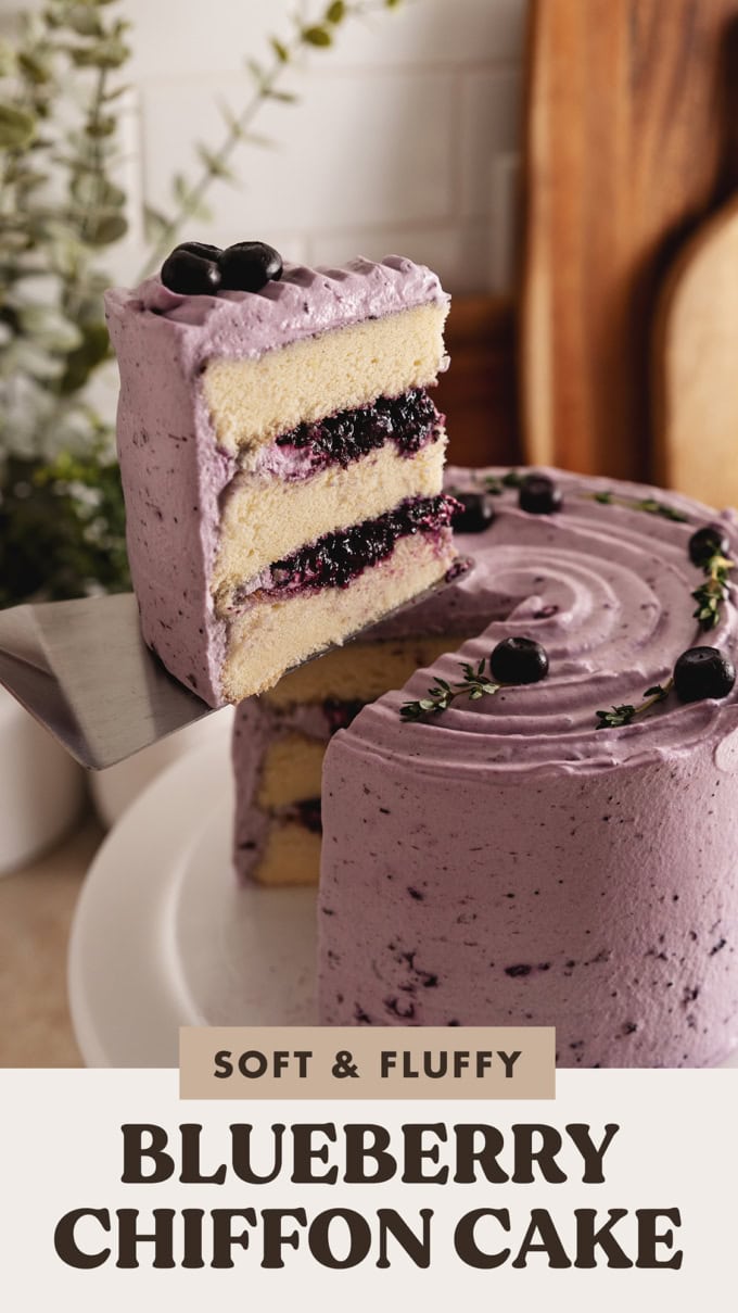 A slice of blueberry chiffon cake lifted from the rest of the cake with a cake server.