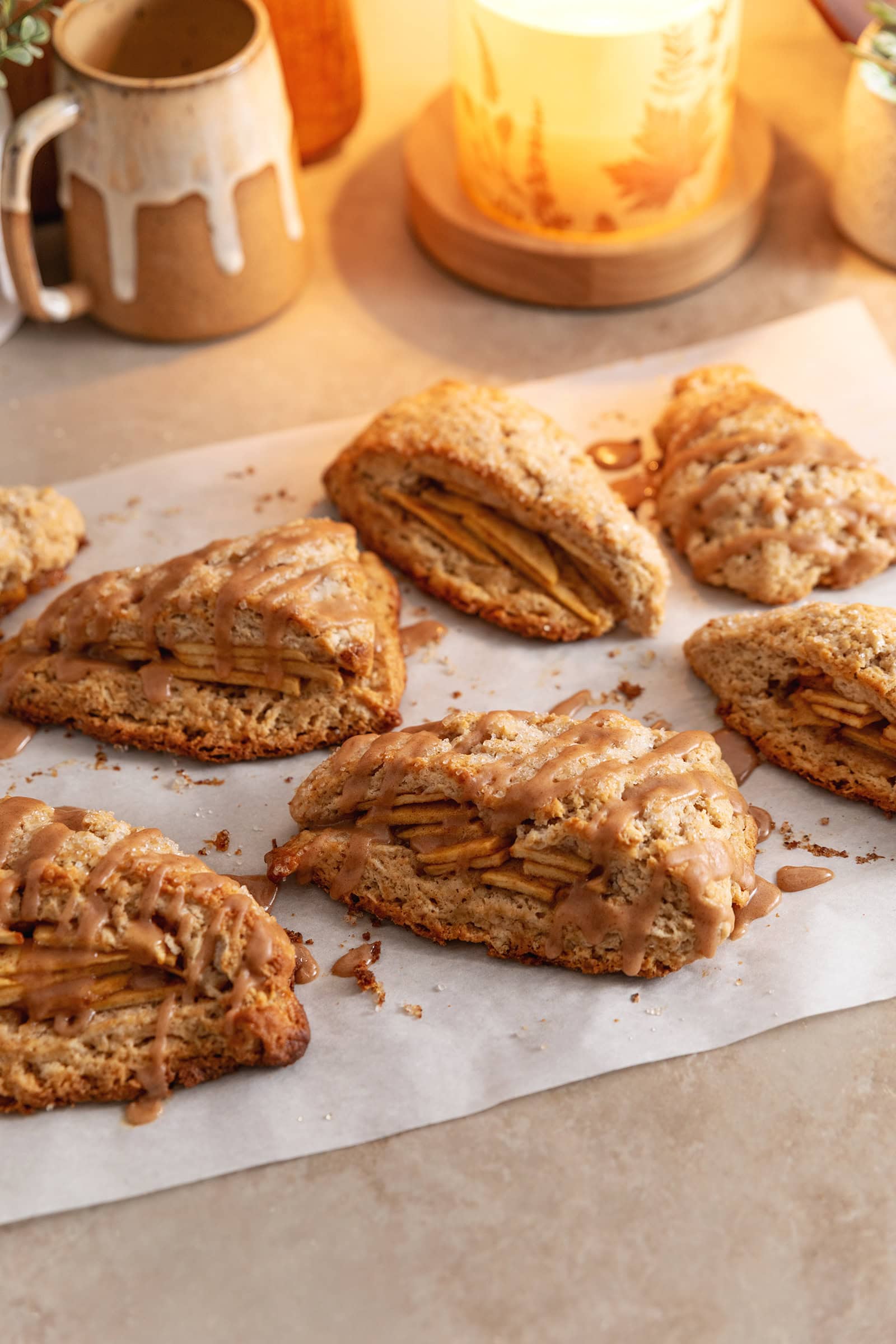 Several cinnamon apple scones scattered on parchment paper.
