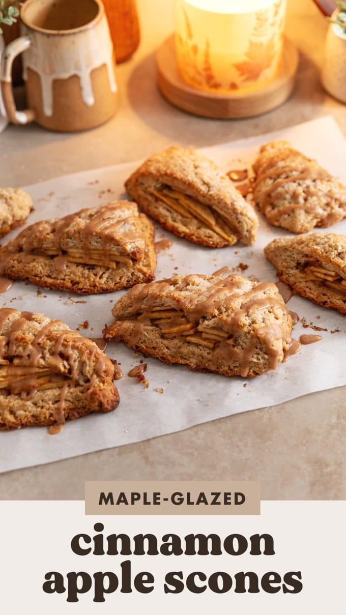 Several cinnamon apple scones scattered on parchment paper.