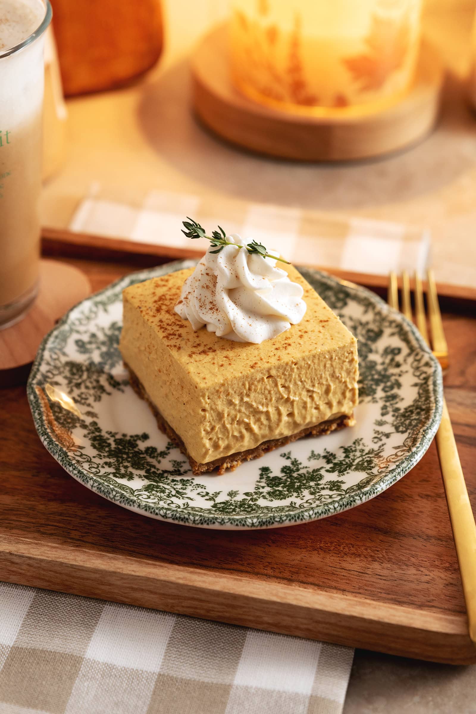 A no-bake pumpkin cheesecake bar on a green floral plate.