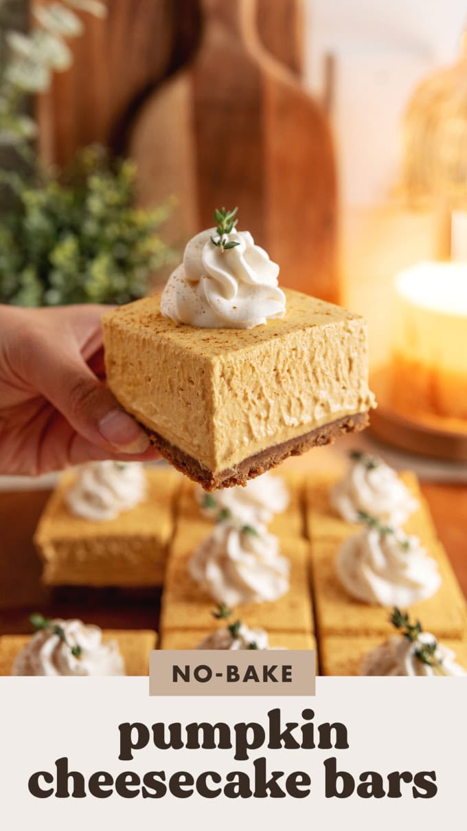 Hand holding a pumpkin cheesecake bar.
