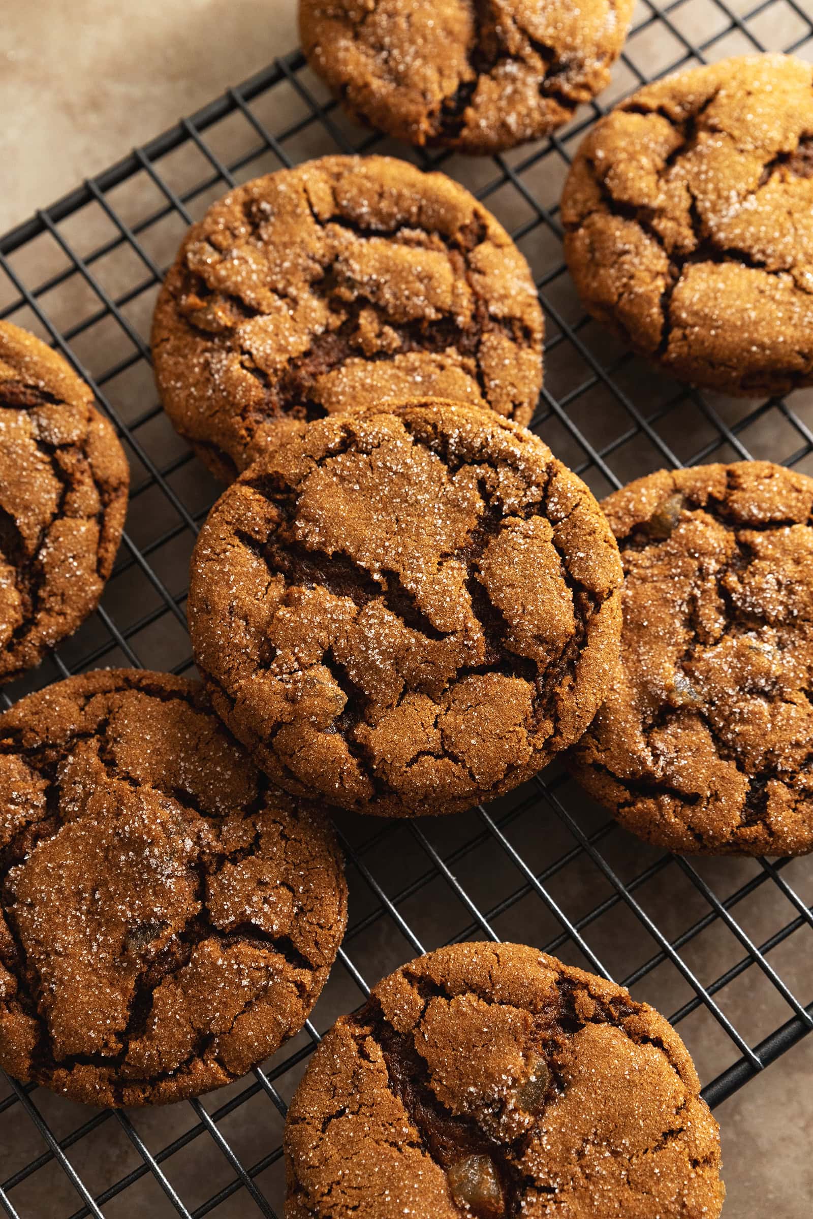 Chewy ginger cookies scattered on a wire rack.