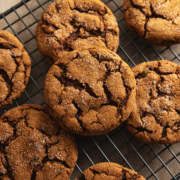 Chewy ginger cookies scattered on a wire rack.