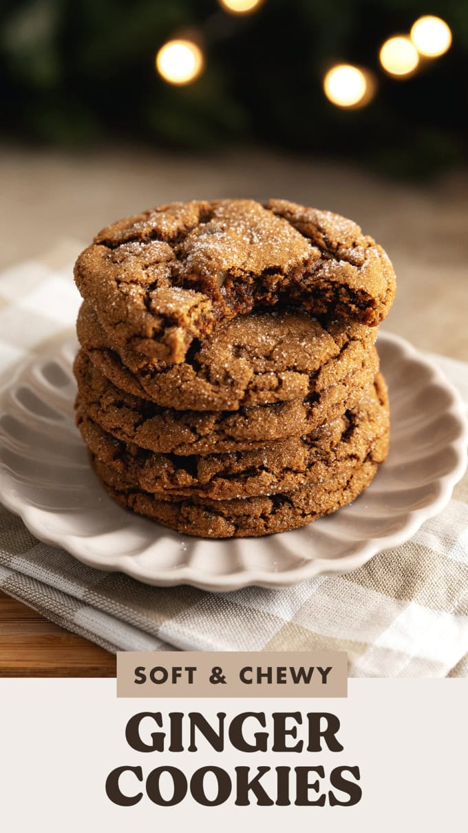 A stack of chewy ginger cookies with a bite taken out of the cookie on top.