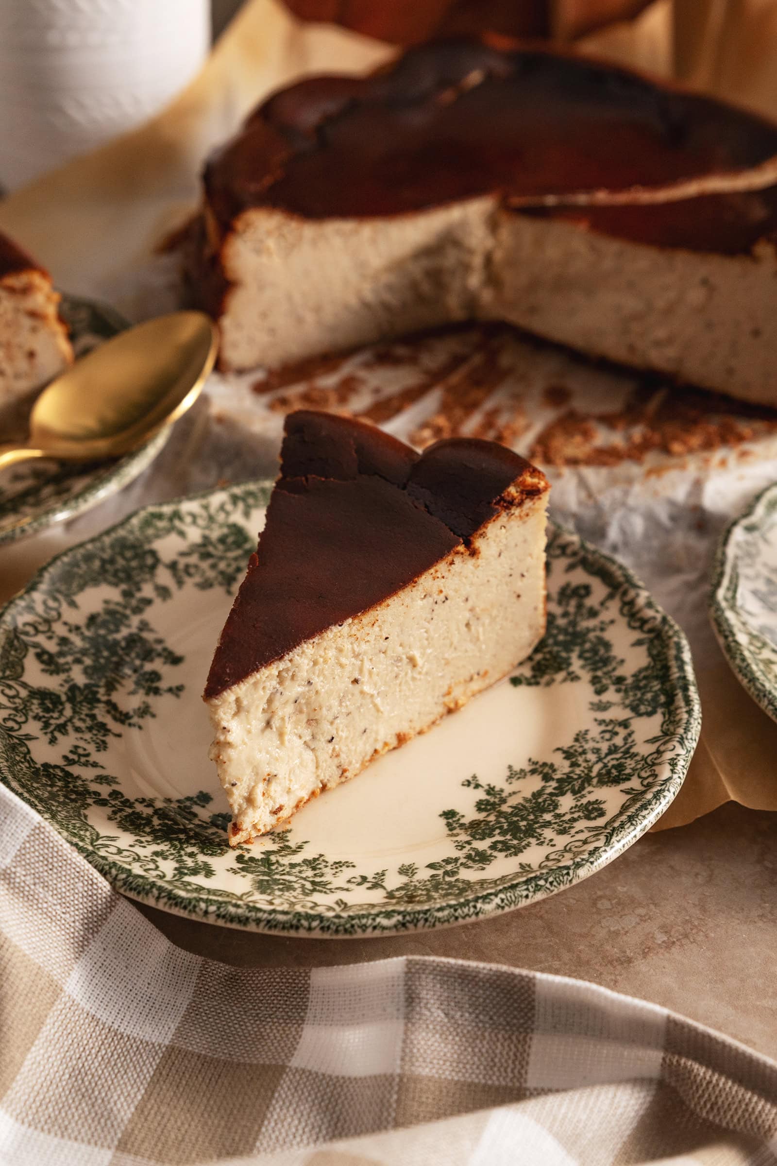 A slice of earl grey basque cheesecake on a floral plate.