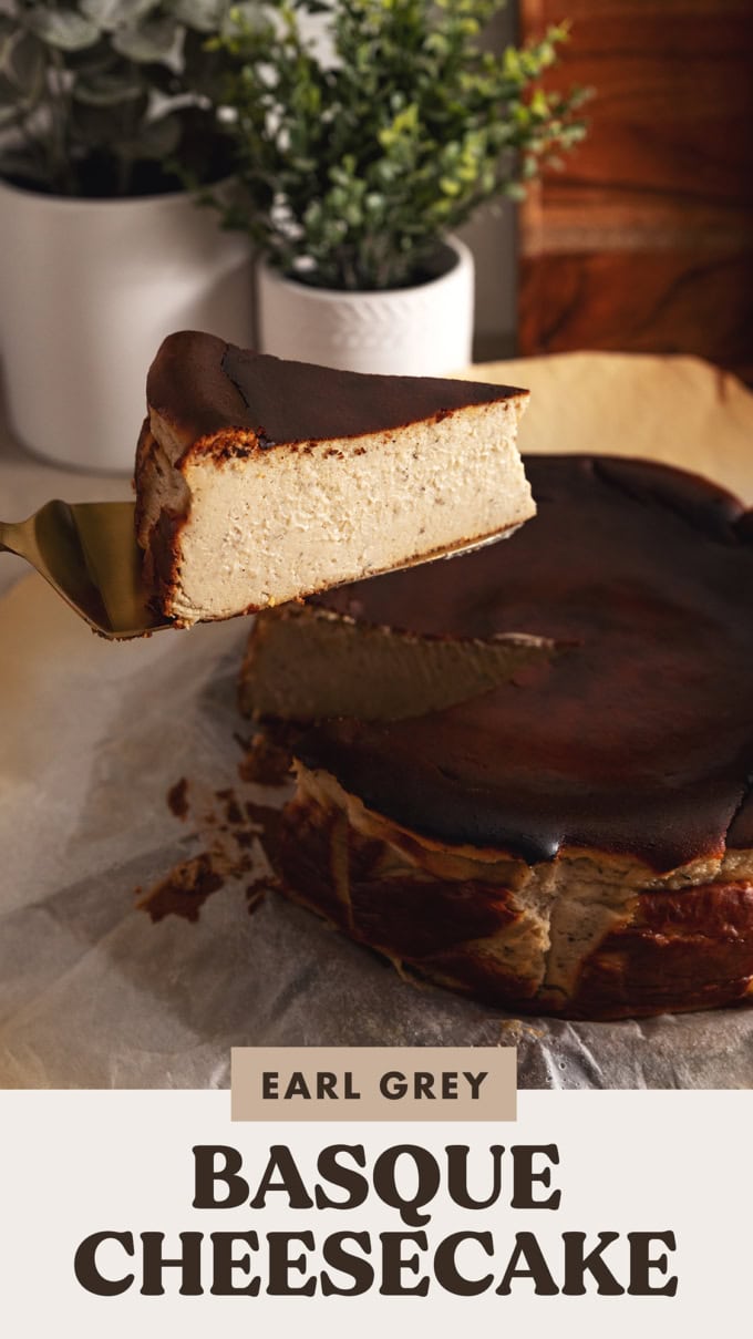 A slice of earl grey basque cheesecake lifted with a cake server above the rest of the cheesecake.