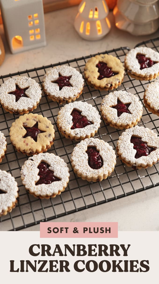 Cranberry linzer cookies lined up on a wire rack.