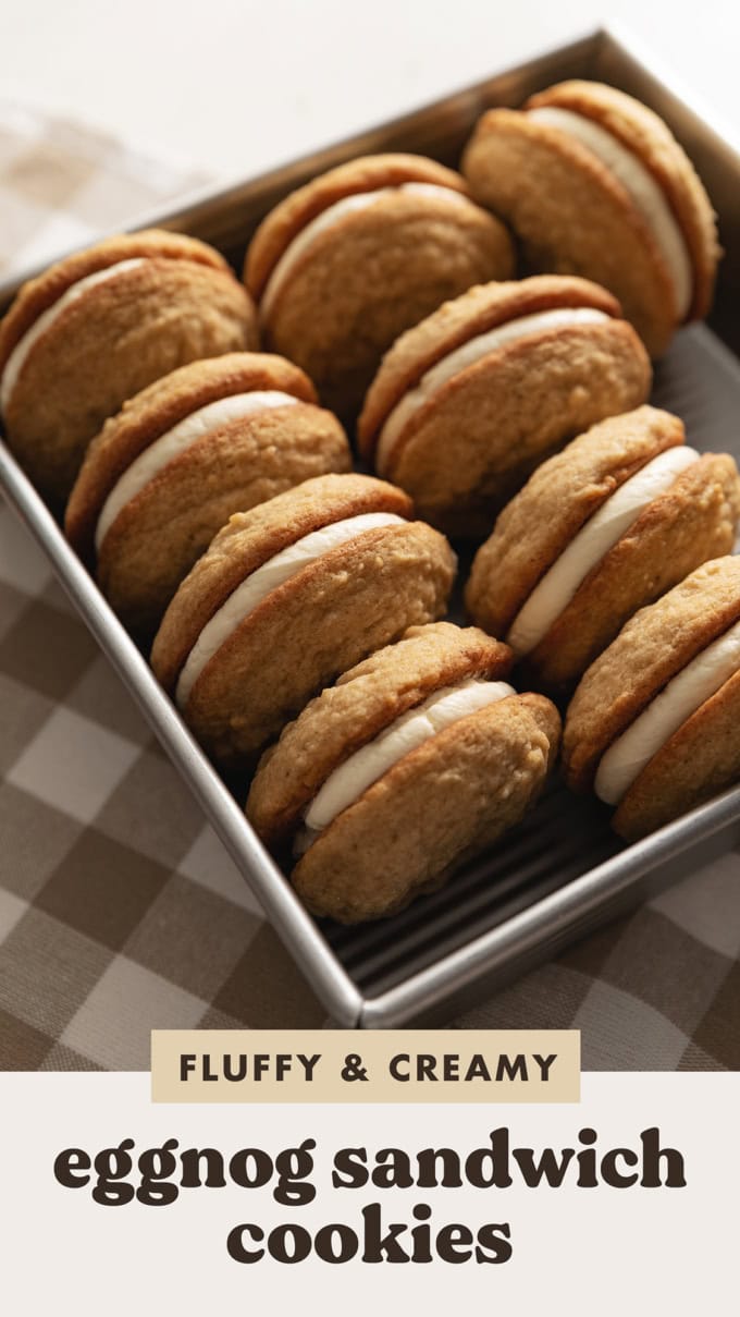 Eggnog sandwich cookies lined up in a baking pan.