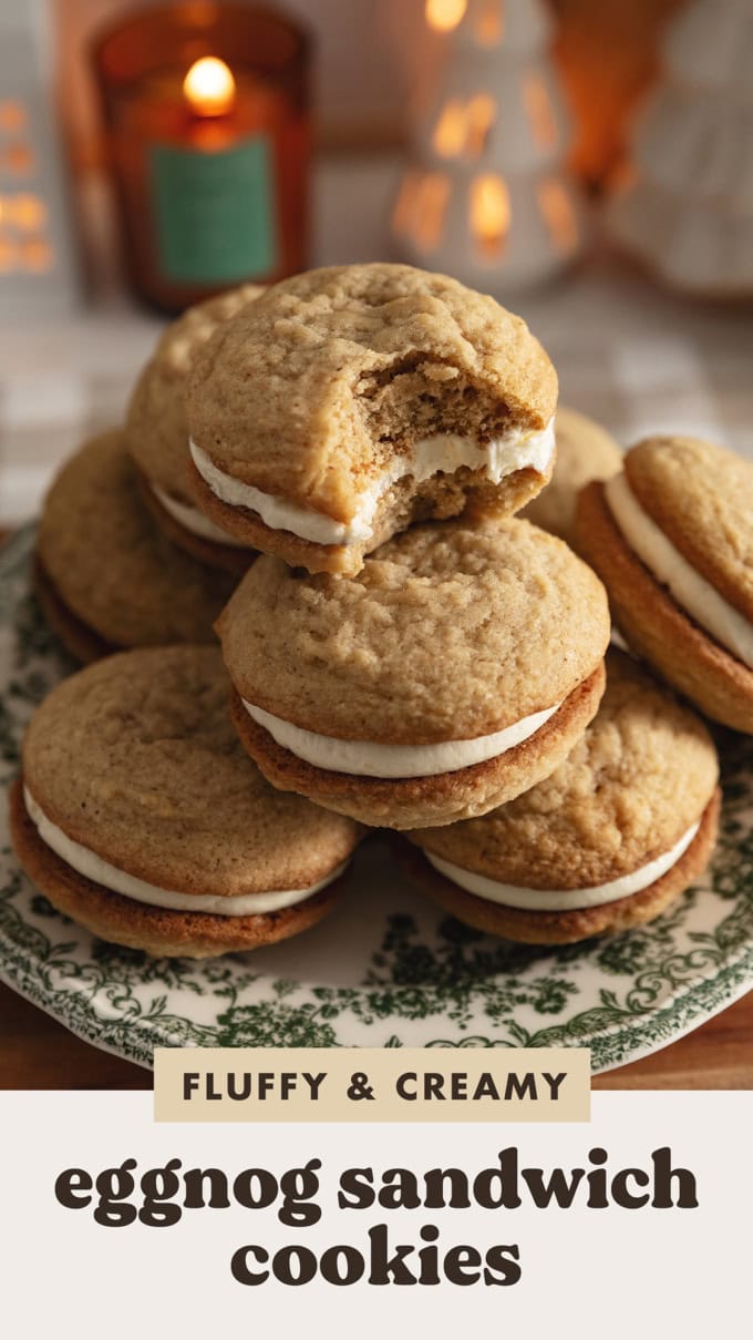 A stack of eggnog sandwich cookies with a bite taken out of the cookie on top.