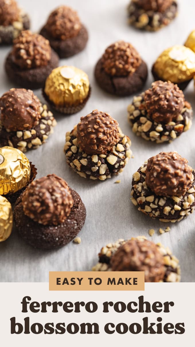 Ferrero rocher blossom cookies scattered on parchment paper with wrapped chocolates around them.