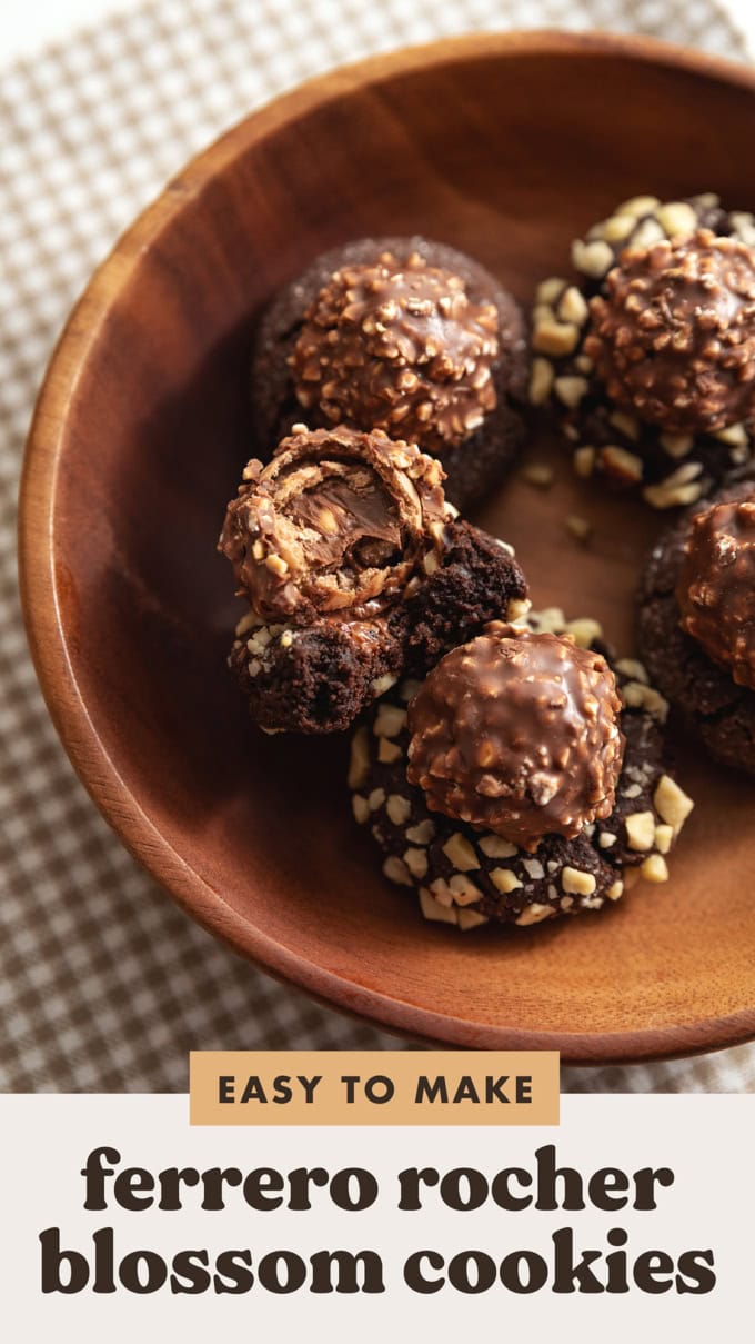 A ferrero rocher blossom cookie with a bite taken out of it in a wooden bowl.