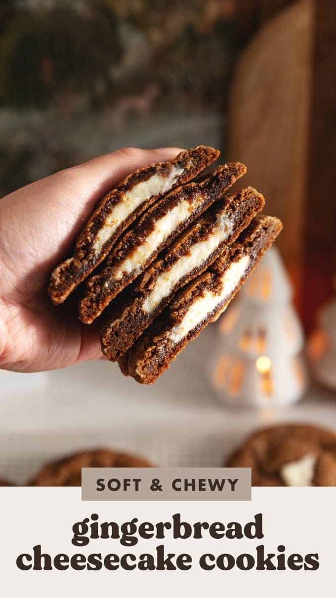 Hand holding a stack of gingerbread cheesecake cookies that are cut in half to show the cheesecake filling inside.