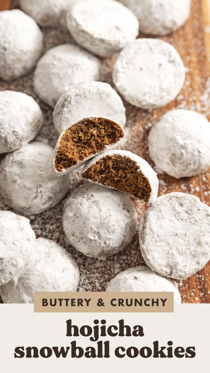 Two hojicha snowball cookies with bites taken out of them among several other cookies dusted with powdered sugar.