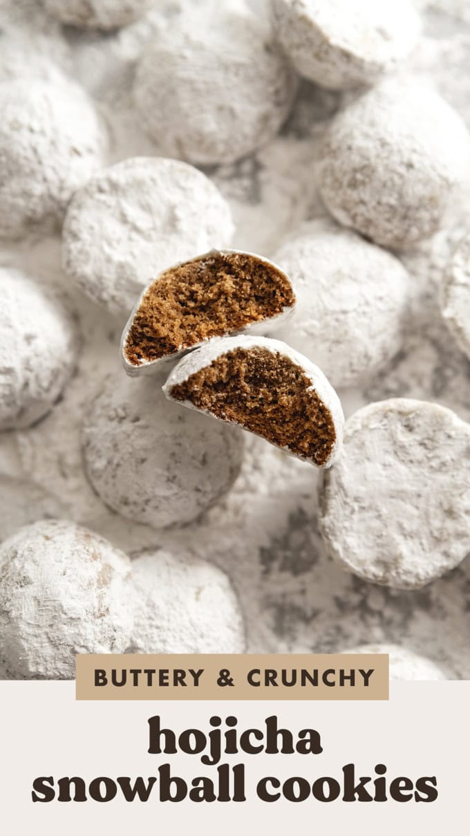 Two hojicha snowball cookies with bites taken out of them among several other cookies dusted with powdered sugar.