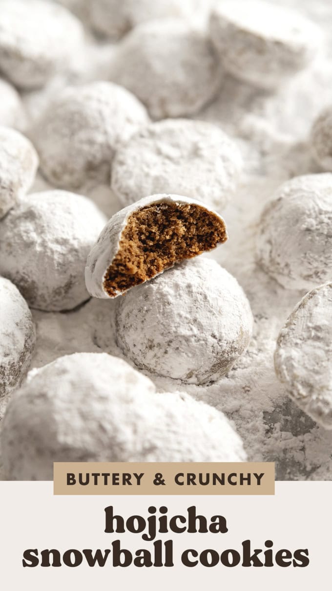 A hojicha snowball cookie with a bite taken out of it among several other cookies dusted with powdered sugar.