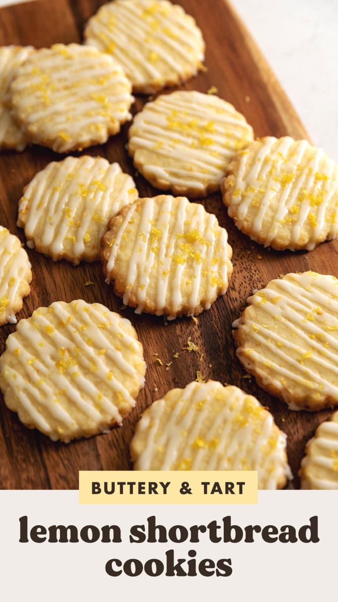 Lemon shortbread cookies scattered on a wooden platter.
