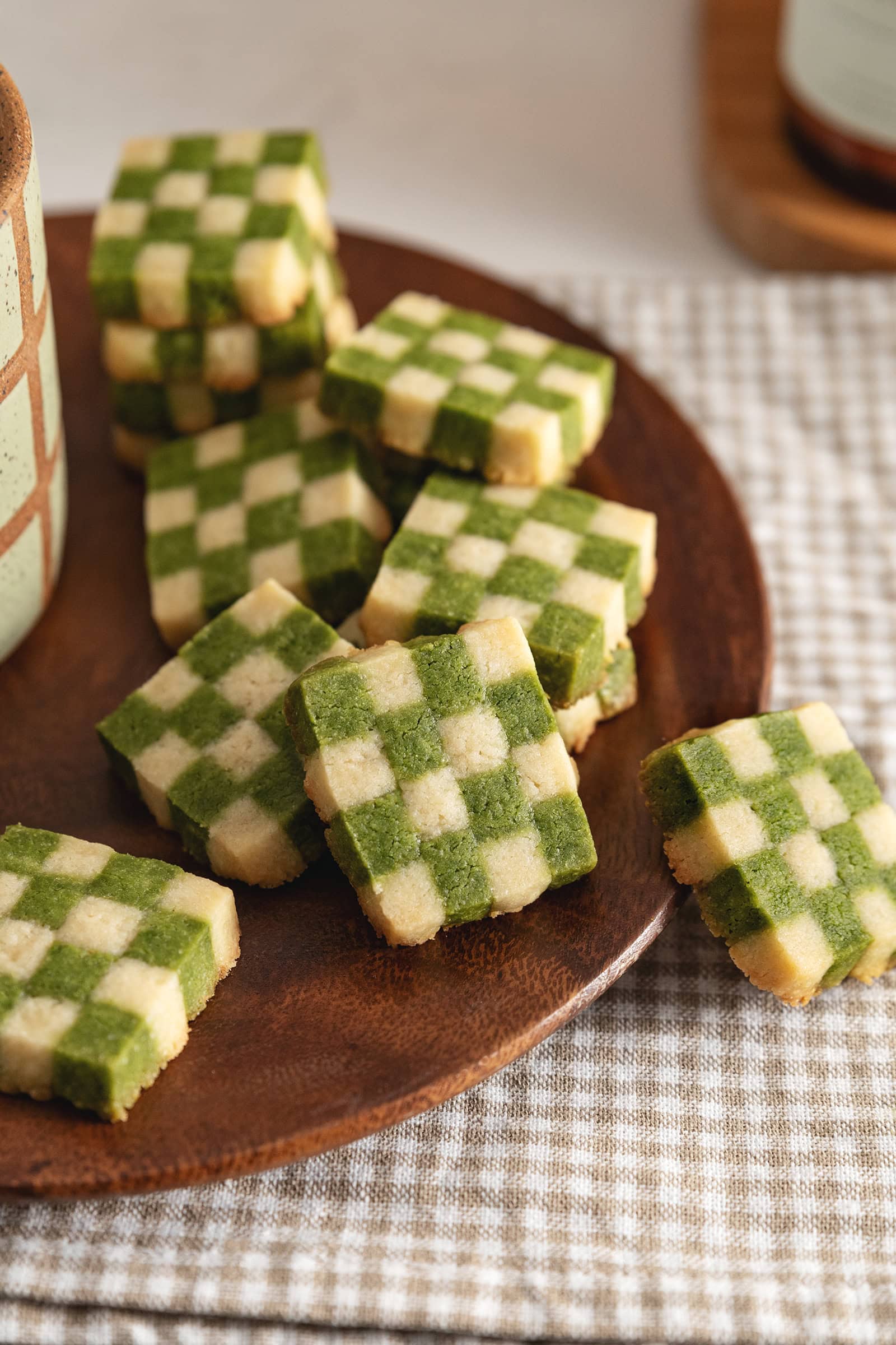 Matcha checkerboard cookies piled on a plate.