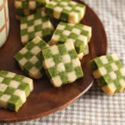 Matcha checkerboard cookies piled on a plate.