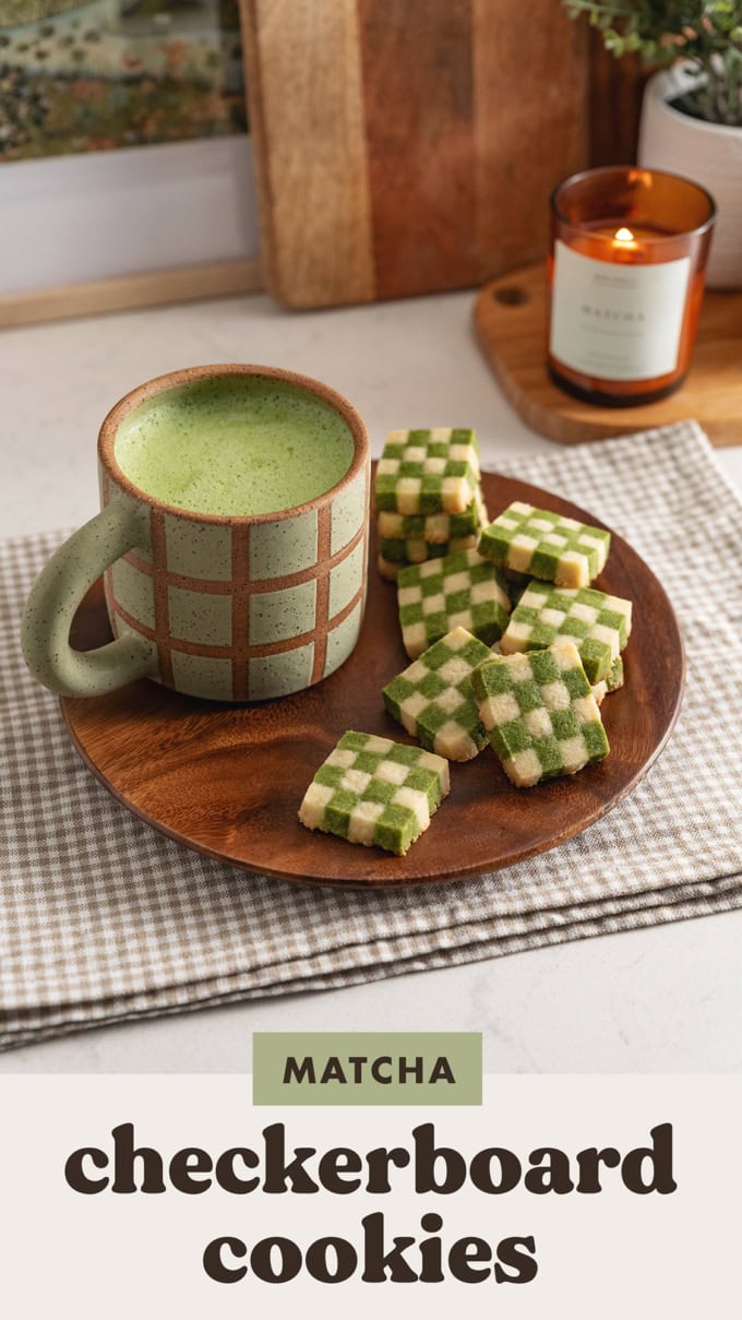 Matcha checkerboard cookies on a plate with a mug of matcha latte.