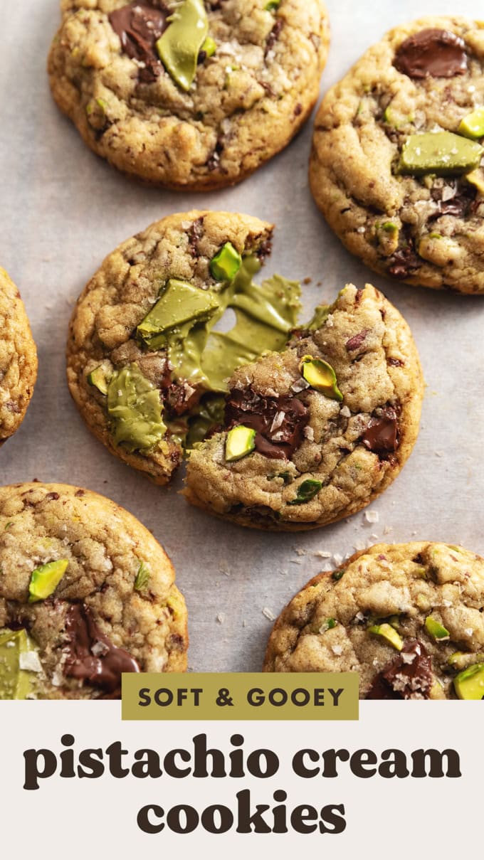 A pistachio cream cookie split in half to show the pistachio cream inside.