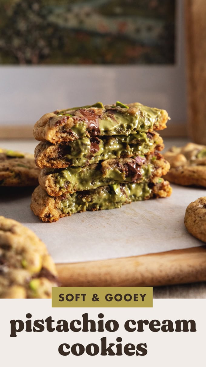 A stack of pistachio cream cookies cut in half to show the pistachio filling inside.
