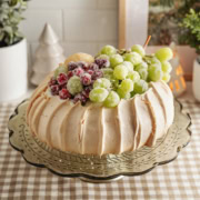 A sugared fruit pavlova on a cake stand.