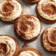 Overhead view of tiramisu cookies scattered on parchment paper.