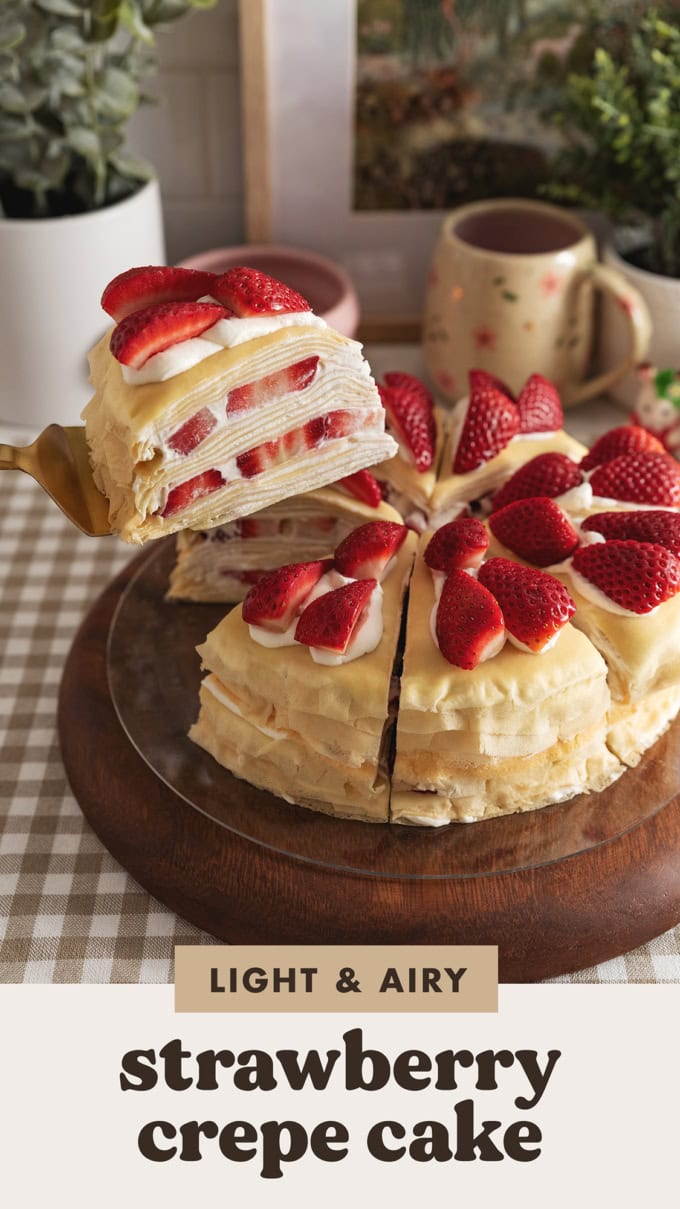 Lifting a slice of strawberry crepe cake above the the rest of the slices.