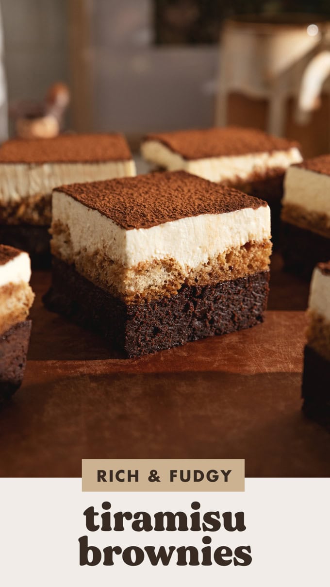Tiramisu brownies scattered on a wooden board.